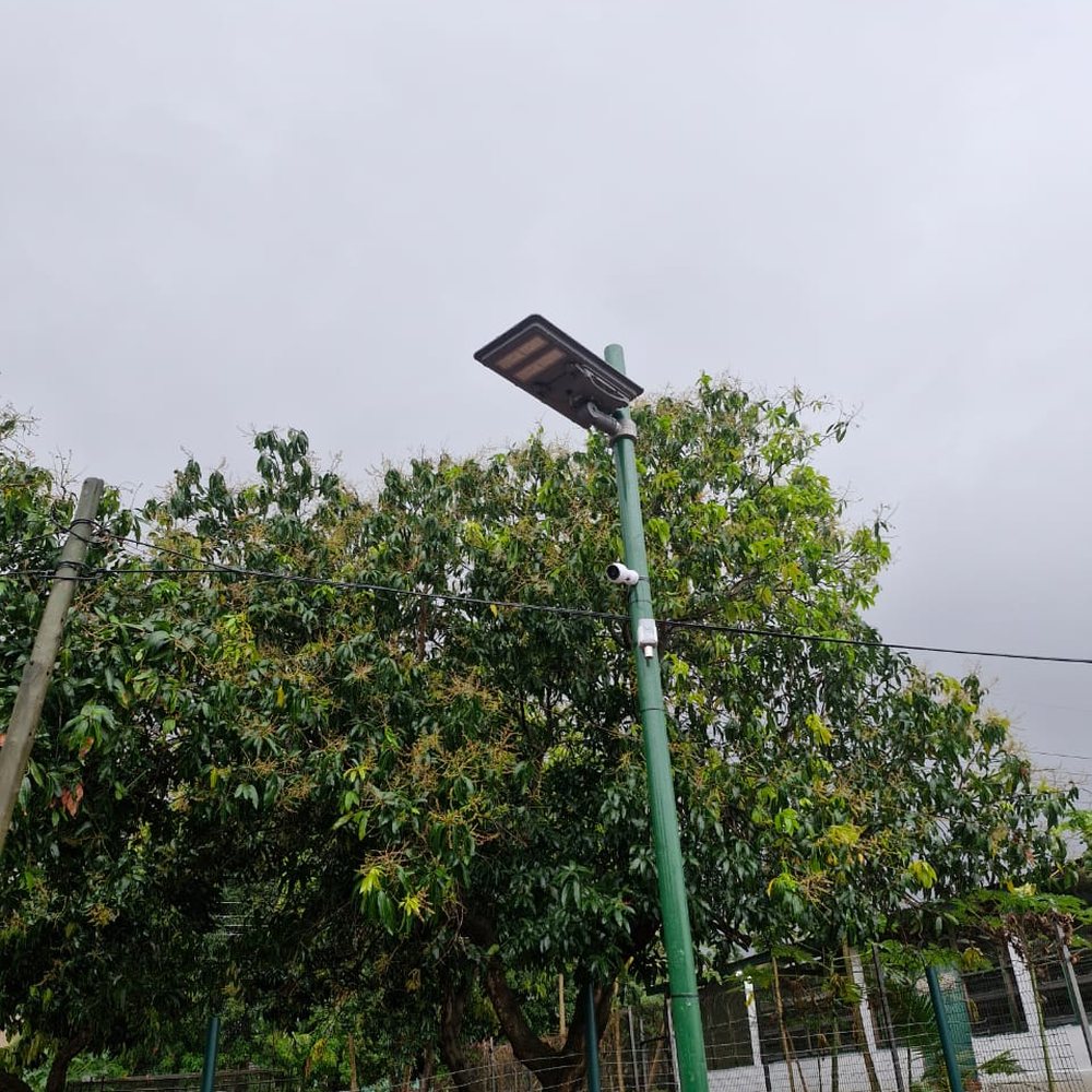 A camera and solar light on one pole at a monitored site